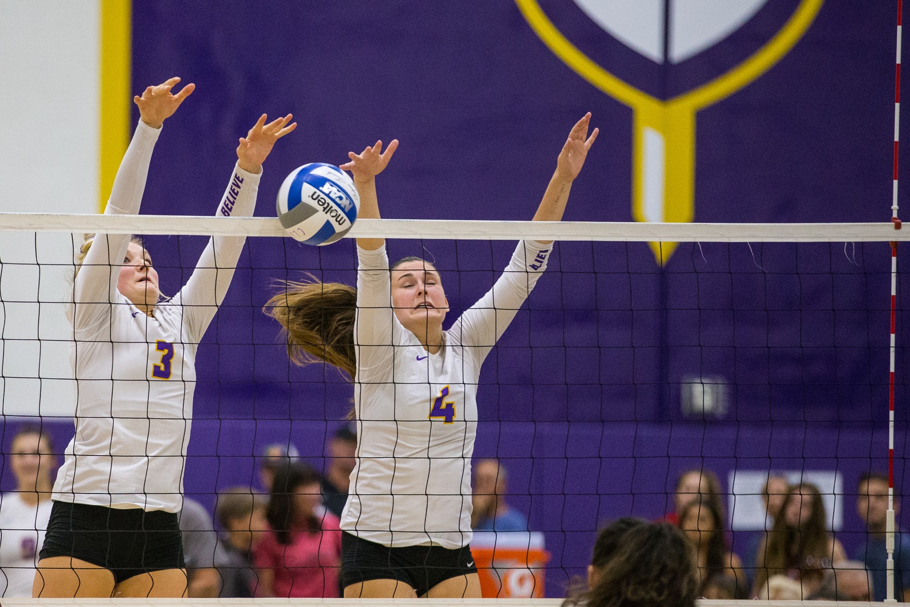 Maci Haddad (left) and Amanda Roberts (right) helped the Regals total a season-high 16 blocks in a 3-2 win against Chapman.